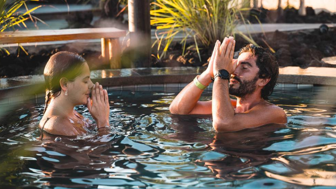 Man and woman practicing mindfulness during an outdoor ice bath.
